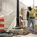Groundsman Brian Krause installs a light post near the East Stadium bridge on Tuesday. Daniel Brenner I AnnArbor.com